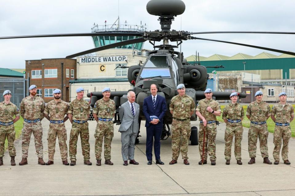 After the ceremony, the father-son duo posed for photos in front of the Apache helicopter with members of the Army Air Corps. Chris Jackson/Getty Images