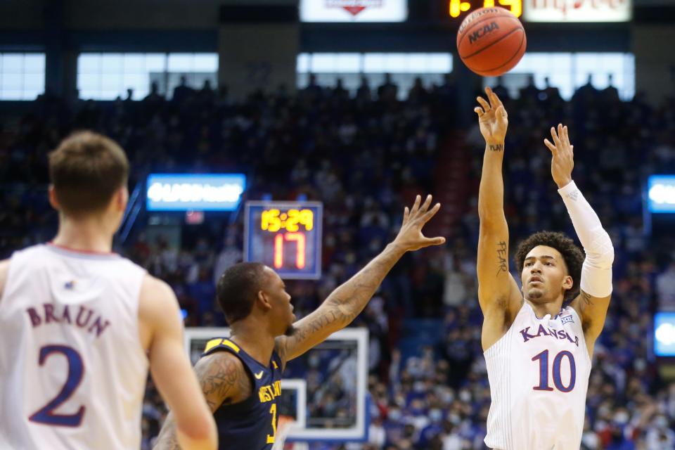 Kansas redshirt sophomore guard Jalen Wilson (10) shoots for three against West Virginia during the first half of Saturday's game inside Allen Fieldhouse.