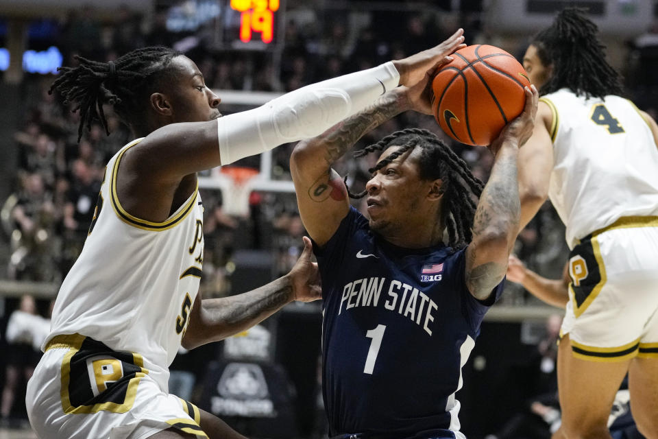 Purdue guard Lance Jones (55) stops Penn State guard Ace Baldwin Jr. (1) as he drives to the basket during the first half of an NCAA college basketball game in West Lafayette, Ind., Saturday, Jan. 13, 2024. (AP Photo/Michael Conroy)