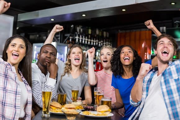 Friends watching sports at a sports bar.