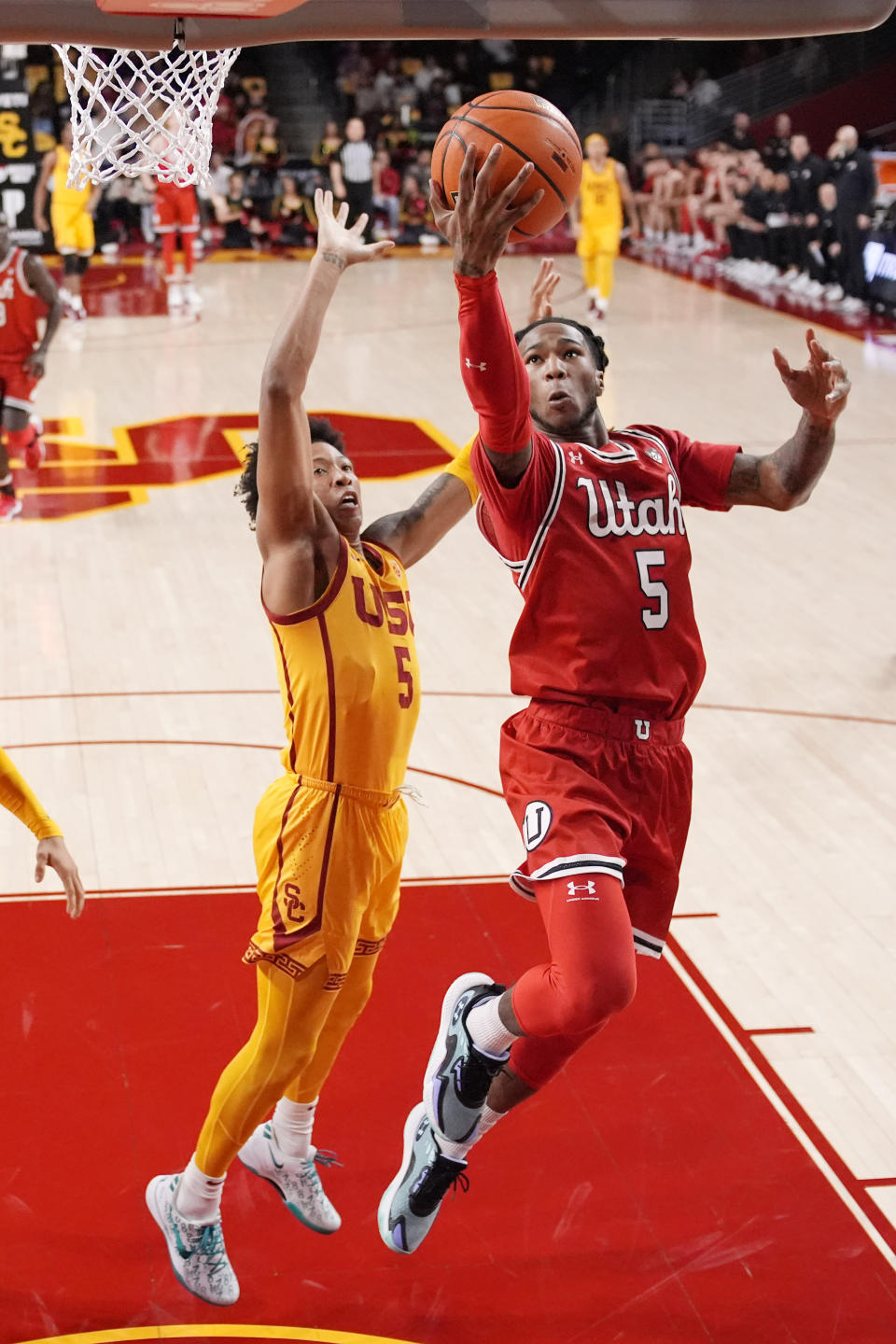 Utah guard Deivon Smith, right, shoots as Southern California guard Boogie Ellis defends during the first half of an NCAA college basketball game Thursday, Feb. 15, 2024, in Los Angeles. (AP Photo/Mark J. Terrill)