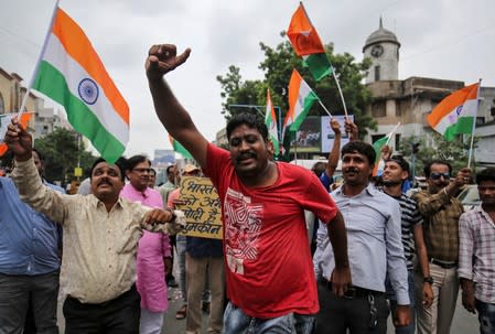 People shout slogans as they celebrate after the government scrapped the special status of Kashmir, in Ahmedabad