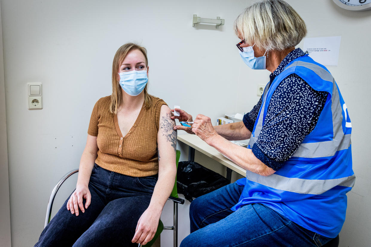 THE HAGUE, NETHERLANDS - MARCH 21: A health worker administers a dose of the Novavax vaccine as the Dutch Health Service Organization starts with the Novavax vaccination program on March 21, 2022 in The Hague, Netherlands. The Novavax vaccine is a protein-based vaccine which can offer an alternative for people who are hesitant about immunisation with an mRNA vaccine or vector vaccine, or for people who have a contraindication for mRNA vaccines.  (Photo by Patrick van Katwijk/Getty Images)