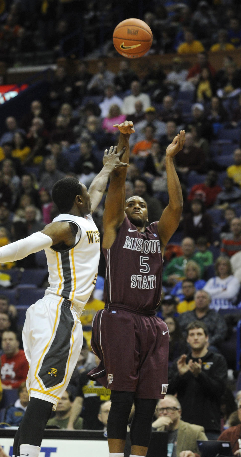 Missouri State's Jarmar Gulley (5) shoots over Wichita State's Cleanthony Early, left, in the first half of an NCAA college basketball game in the semifinals of the Missouri Valley Conference men's tournament, Saturday, March 8, 2014, in St. Louis. (AP Photo/Bill Boyce)