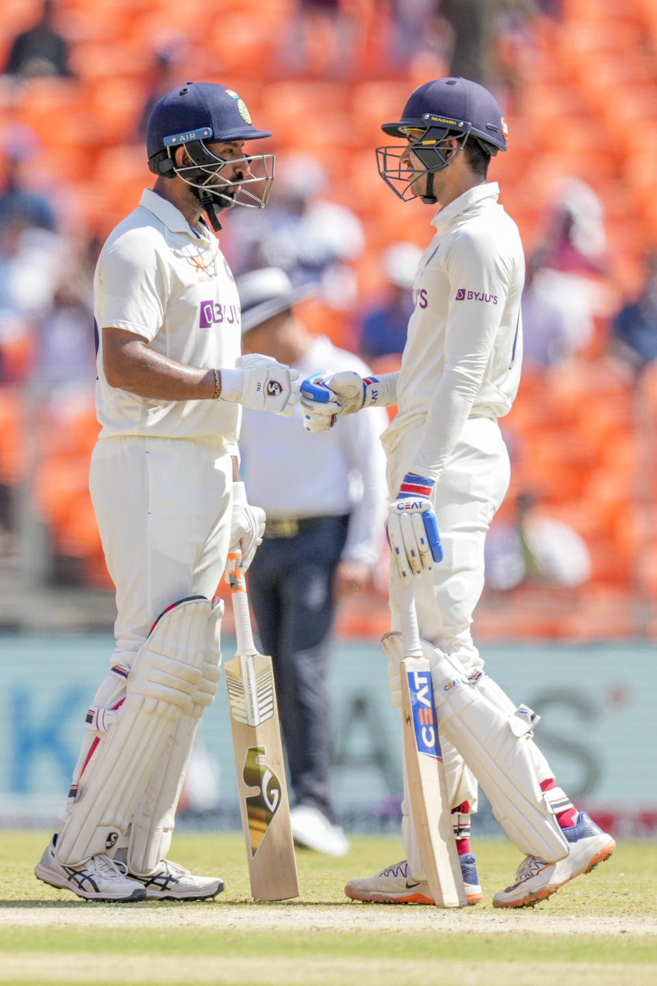 India's Cheteshwar Pujara, left, Shubman Gill chat on the pitch during the third day of the fourth cricket test match between India and Australia in Ahmedabad, India, Saturday, March 11, 2023. (AP Photo/Ajit Solanki)