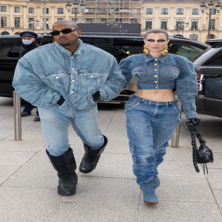 Ye (L) and Julia (R) walking hand-in-hand while in all-denim ensembles