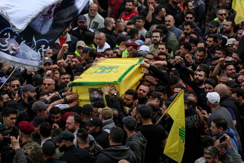 People attend the funeral of Hezbollah commander Ali Ahmed Hussein who was killed in an Israeli air raid. Marwan Naamani/ZUMA Press Wire/dpa