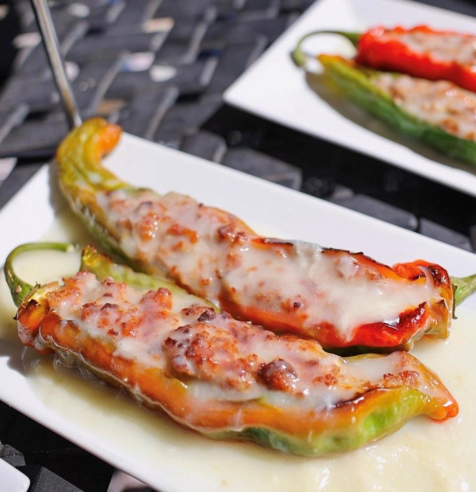 Stuffed Italian long hot peppers, an appetizer of peppers stuffed with ground sweet sausage and mozzarella cheese and topped with a white wine sauce, at Ellery's in Middlesex.