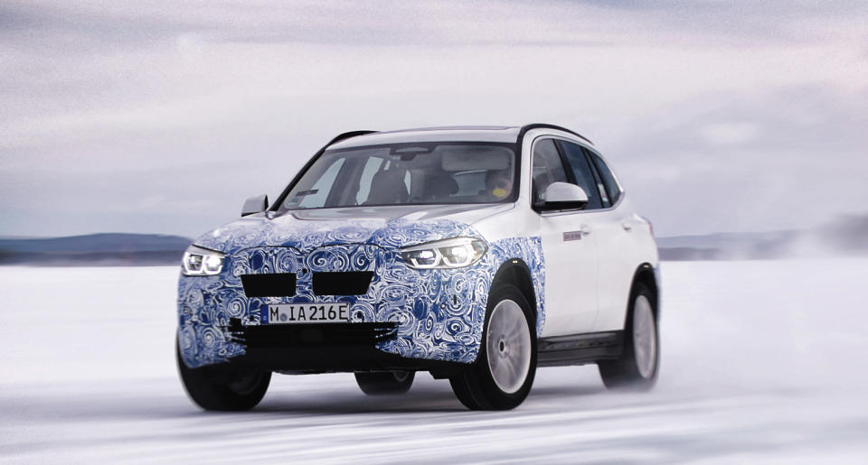 A prototype BMW iX3, a compact electric luxury crossover SUV, shown undergoing winter testing.