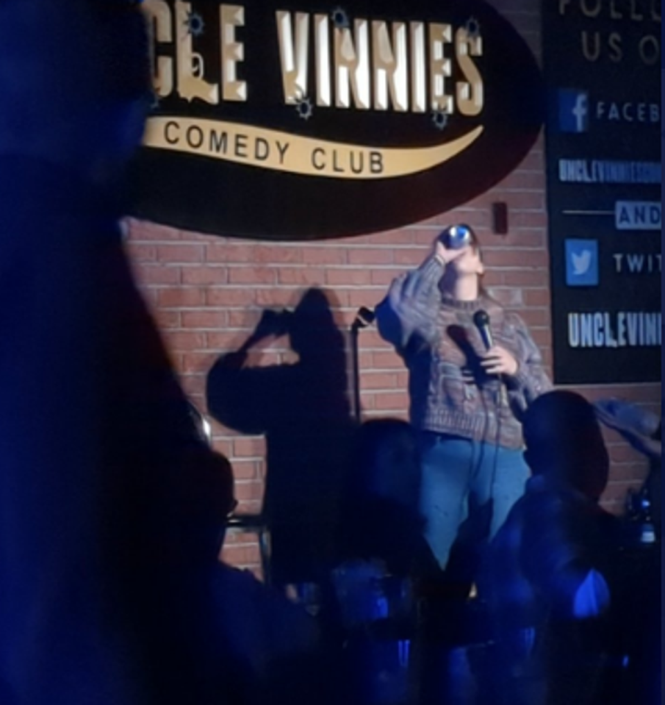 Comedian Ariel Elias can be seen chugging the remnants of a can of beer that was thrown at her during her routine in New Jersey on Saturday 8 October 2022 (Twitter/@Ariel_Comedy)