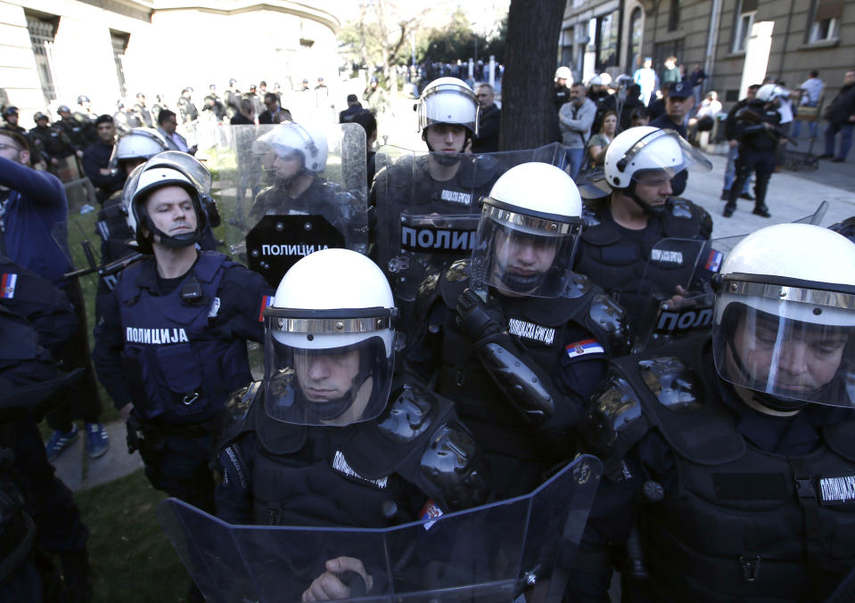 Serbian Gendarmerie members stand guard in front of the Serbian presidency building in Belgrade, Serbia, Sunday, March 17, 2019. As Serbian president Aleksandar Vucic held a news conference in the presidency building in downtown Belgrade, some thousands of opposition supporters gathered in front demanding his resignation. (AP Photo/Darko Vojinovic)