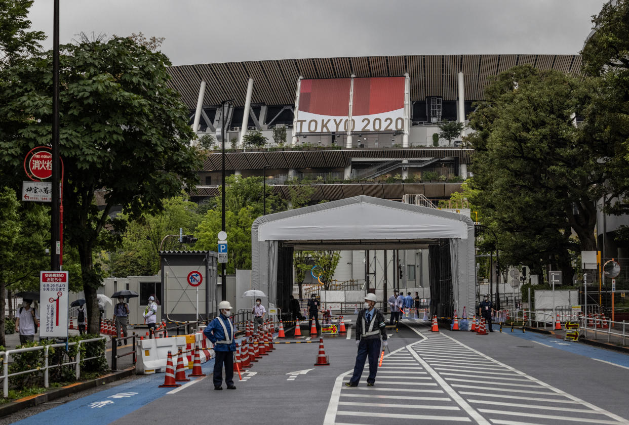 TOKYO, JAPAN - JULY 08: Security guards man an entrance to the Olympic Stadium on July 8, 2021 in Tokyo, Japan. Japans Prime Minister, Yoshihide Suga, has announced a fourth state of emergency for Tokyo which will run throughout the Olympic Games and remain in place until August 22nd. The countrys capital has seen an increase in coronavirus cases with 920 infections registered yesterday, up from 714 last week and the highest figure since May 13th. (Photo by Carl Court/Getty Images)