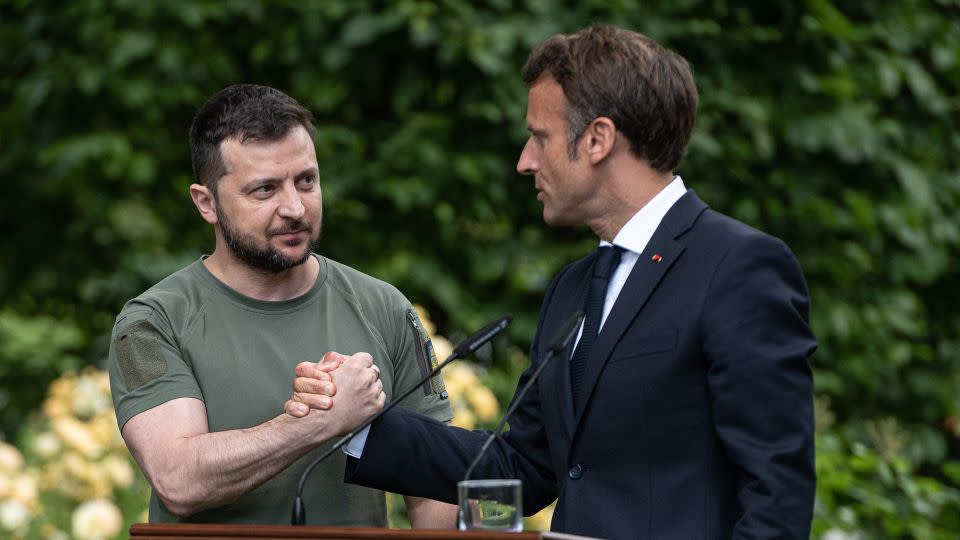 Ukrainian President Volodymyr Zelensky, left, and France's Emmanuel Macron shake hands after a press conference on June 16, 2022 in Kyiv, Ukraine. - Alexey Furman/Getty Images
