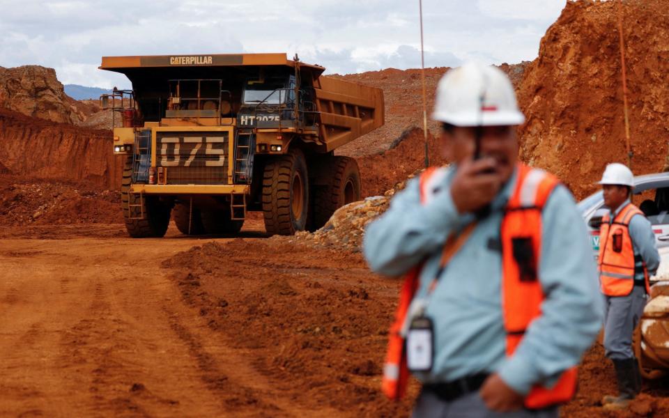 A dump truck loads raw nickel ore at a mining site in South Sulawesi province, Indonesia