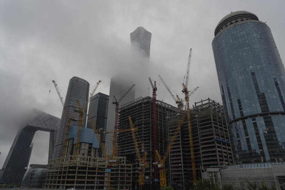 Construction cranes are seen near the China Zun, the tallest building in Beijing, July 30, 2024. (AP Photo/Ng Han Guan)