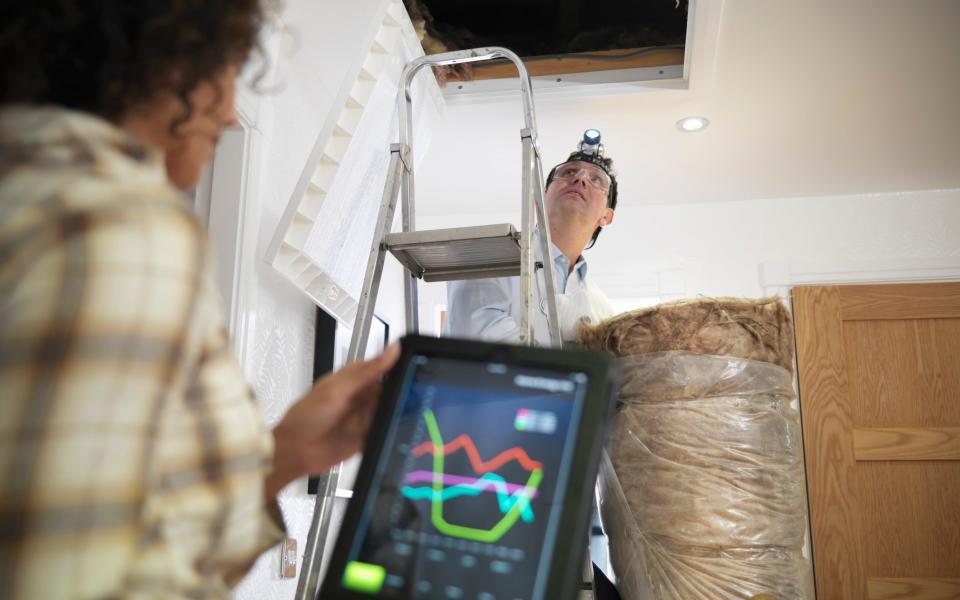 A couple prepare to climb into their loft to fit wool insulation