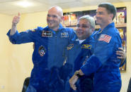 FILE - European Space Agency's astronaut Alexander Gerst, left, Russian cosmonaut Maxim Suraev, center, and NASA astronaut Reid Wiseman, members of the next mission to the International Space Station, embrace during a news conference in Russian leased Baikonur cosmodrome, Kazakhstan, Tuesday, May 27, 2014. Russia will opt out of the International Space Station after 2024 and focus on building its own orbiting outpost, the country's newly appointed space chief said Tuesday, July 26, 2022. (AP Photo/Dmitry Lovetsky, File)