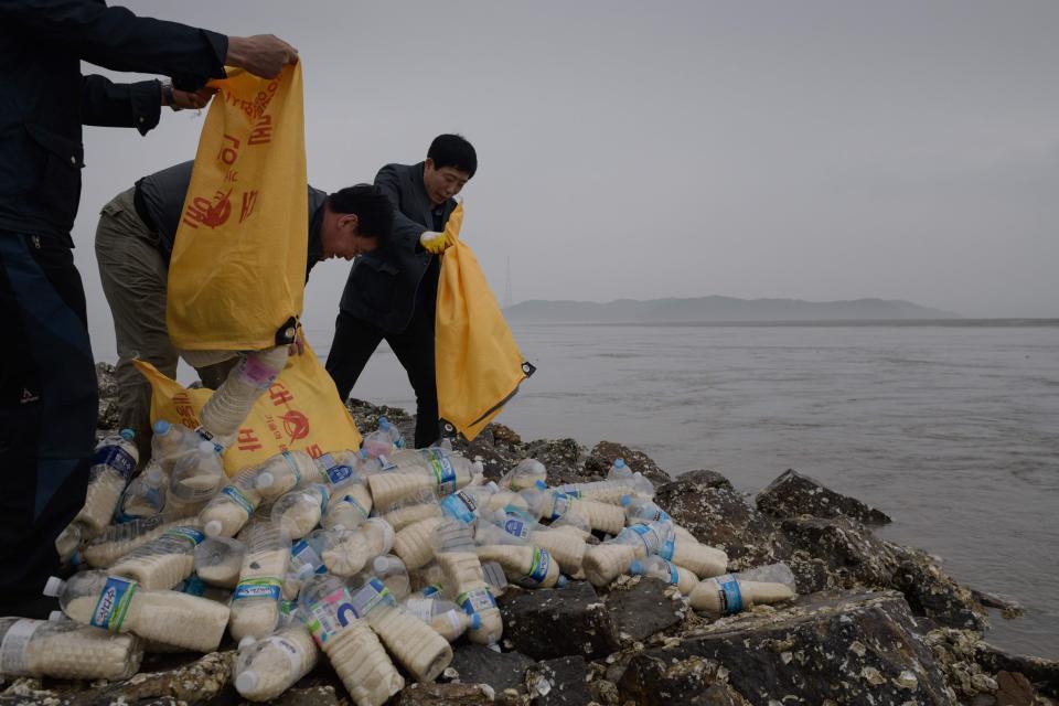 During a previous attempt to send over bottles in 2018, North Korean defector activists empty bags containing rice, money, and USB sticks, on Ganghwa island, west of Seoul.