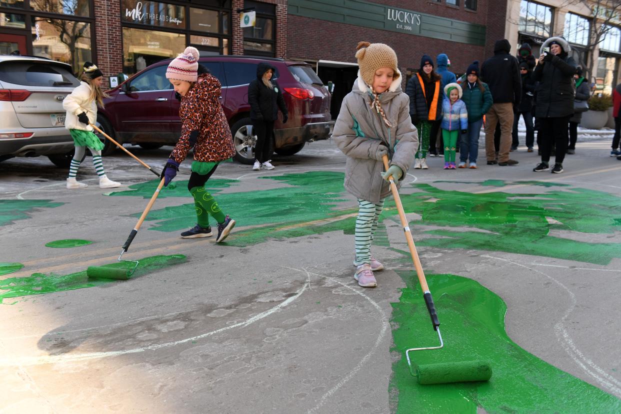 Mila Murphy Branch, 6, and Maggie Okerlund, 6, help paint the shamrock on Phillips Avenue for St. Patrick’s Day on Saturday, March 18, 2023, in downtown Sioux Falls.