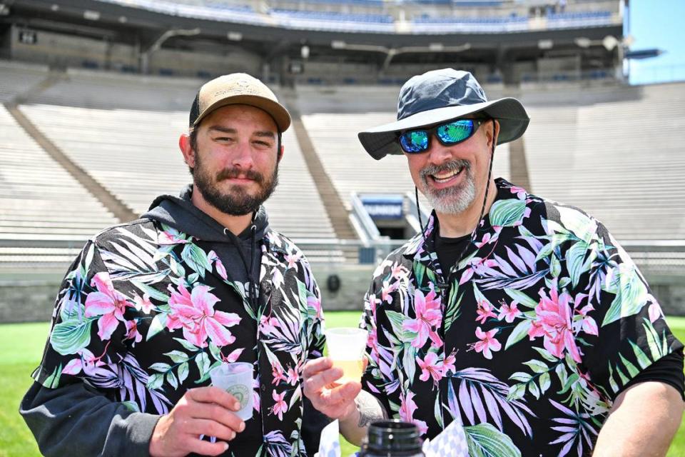 Caleb Johnson, left, and father-in-law Bill Muse pose at the Hoppy Valley Brewers Fest on Saturday at Penn State’s Beaver Stadium. Jeff Shomo/For the CDT