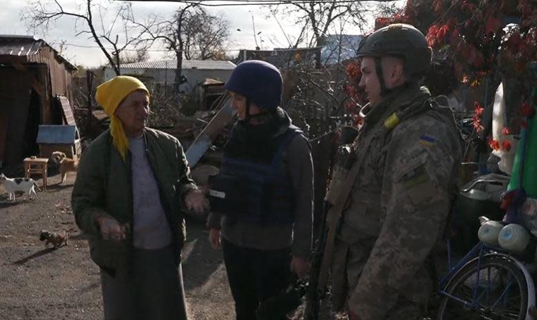Ukrainian Army Private                  Andriy Rogalski (right) speaks with CBS News' Holly Williams and local resident Nadia Sabsai in the town of Vysokopillia, in Ukraine's southern Kherson region, in early November 2022. / Credit: CBS News