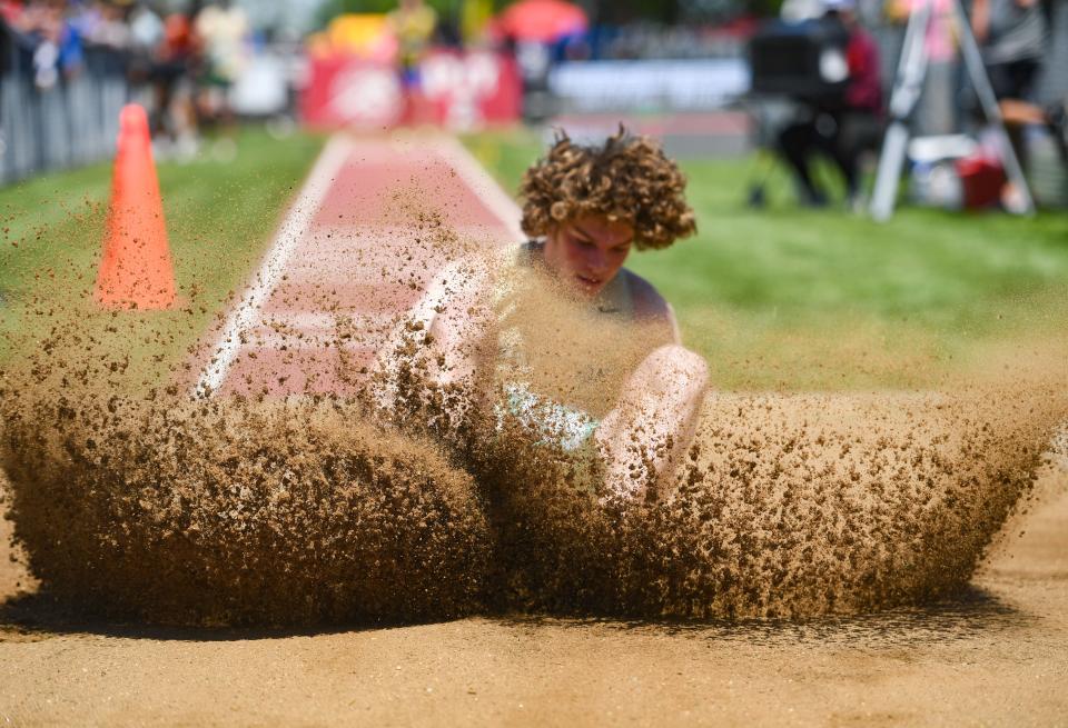 Curls bounce on the head of Jefferson's Griffin Wilde as he hits the sand pit during the long jump on the first day of state track on Thursday, May 26, 2022, at Howard Wood Field in Sioux Falls.