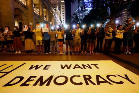 Protesters hold hands to form a human chain during a rally to call for political reforms in Hong Kong's Central district