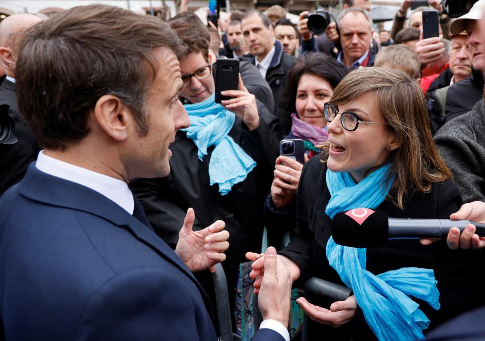 French President Emmanuel Macron argues with a person opposed to the pension reform, in Selestat, eastern France, Wednesday, April 19, 2023. French President Emmanuel Macron said Monday April 17, 2023 that he heard people's anger over raising the retirement age from 62 to 64, but insisted that it was needed to keep the pension system afloat as the population ages. Emmanuel Macron is trying to repair the damage done to his public image and politics by forcing the pension plan through parliament last month. (Ludovic Marin, Pool via AP)