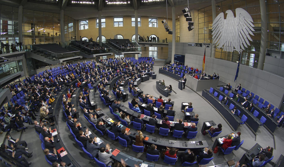 FILE - German Chancellor Olaf Scholz delivers a speech during a meeting of the German federal parliament, Bundestag, at the Reichstag building in Berlin, Germany, Dec. 15, 2021.Germany's parliament is expected to approve on Wednesday a resolution labeling as genocide Ukraine's "Holodomor" of the 1930s, a famine believed to have killed more than 3 million Ukrainians under the repressive rule of Soviet leader Josef Stalin. The resolution is being brought to the lower house, or Bundestag, by the three parties in Chancellor Olaf Scholz's governing coalition and the main opposition bloc. (AP Photo/Michael Sohn, File)