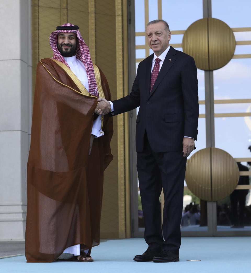 Turkish President Recep Tayyip Erdogan, right, and Saudi Crown Prince Mohammed bin Salman shake hands during a welcome ceremony, in Ankara, Turkey, Wednesday, June 22, 2022. Saudi Crown Prince arrived in Ankara on Wednesday, making his first visit to Turkey following the slaying of Saudi columnist Jamal Khashoggi in Istanbul. Saudi Arabia and Turkey press ahead with efforts to repair ties that were strained by Khashoggi's killing. (AP Photo/Burhan Ozbilici)