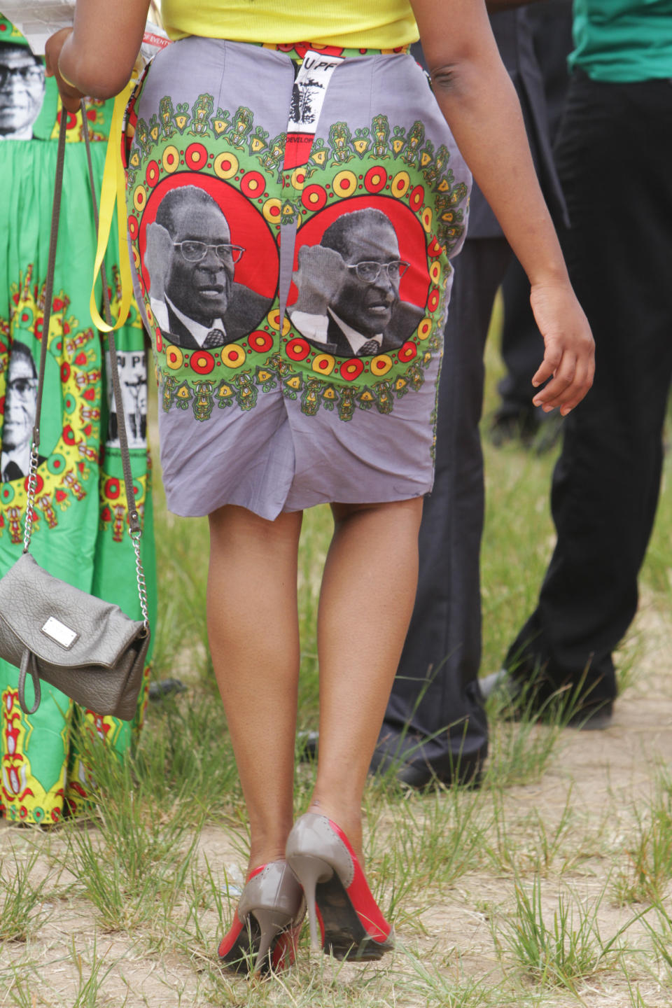 A supporter of Zimbabwean President Robert Mugabe wears a dress with his portrait during celebrations to mark his 90th birthday in Marondera about 100 km east of Harare, Sunday, Feb. 23, 2014. Mugabe who is Africas oldest leader has been in power in the Southern African nation since 1980. (AP (AP Photo/Tsvangirayi Mukwazhi)