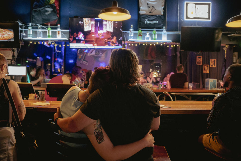 A couple embraces while hanging out at Sapphic Sunday at Dru’s.<span class="copyright">Andrea Morales for TIME</span>