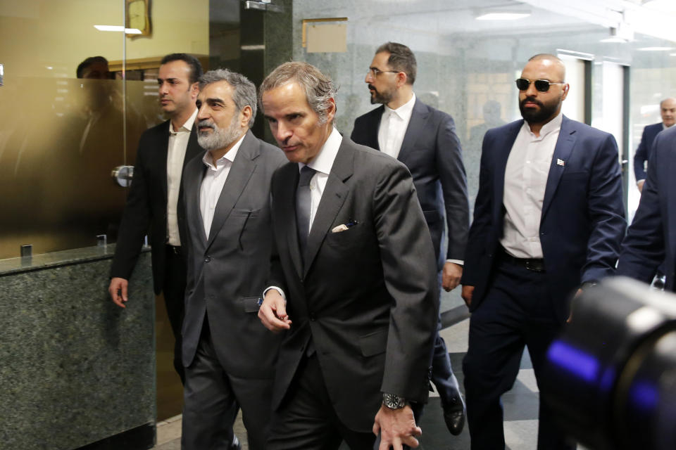 International Atomic Energy Organization, IAEA, Director General Rafael Mariano Grossi, center, arrives for a meeting with head of Atomic Energy Organization of Iran Mohammad Eslami as he is welcomed by the spokesman for Iran's atomic agency Behrouz Kamalvandi, second left, in Tehran, Saturday, March 4, 2023. (AP Photo/Vahid Salemi)