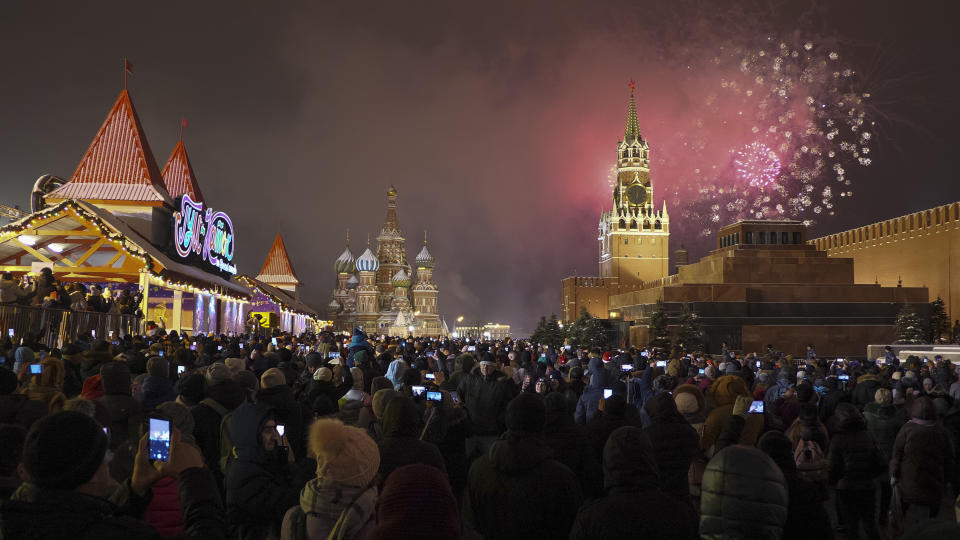 Fireworks explode over the Kremlin during New Year's celebrations in Red Square with St. Basil's Cathedral, center, and the Spasskaya Tower, right, in the background in Moscow, Russia