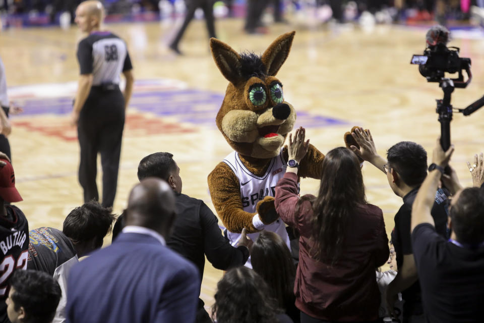 The mascot for the San Antonio Spurs greets fans during an NBA basketball game against Miami Heat, at the Mexico Arena in Mexico City, Saturday, Dec. 17, 2022. (AP Photo/Christian Palma)