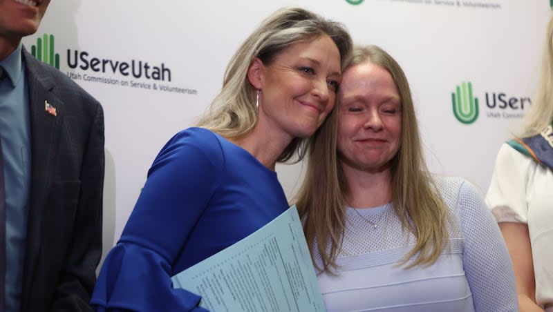 Leah Moses, mother of Om Moses Gandhi, left, and Shaynie Hunter, embrace after the signing of HB 272 at the University of Utah Bennion Center in Salt Lake City on Wednesday, April 10, 2024. HB272, Keep Children Safe from Family Violence, is also known as Om’s Law. The bill is named after Om Gandhi, a Salt Lake City teenager killed by his father, who then killed himself. Before Om was killed, his parents had a lengthy custody battle. The father was given full custody around a year before Om’s death.