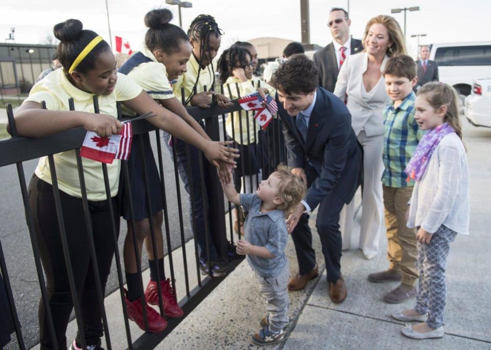 Prime MinisterJustin Trudeau helps his son Hadrian greet a group of school children as his wife Sophie and children Xavier and Ella-Grace look on during welcome ceremony at Andrews Air Force Base, Md., Wednesday, March 9, 2016. THE CANADIAN PRESS/Paul Chiasson