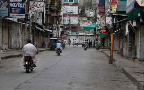 Motorcyclists ride through a market which is closed due to a strike in Rawalpindi, Pakistan, Saturday, July 13, 2019. Pakistani traders have largely kept their business shut across the country against the new sales tax regime in the first budget of the new government they and opposition parties said came on the diktat of International Monetary Fund in turn of a $6bn bailout package - Credit: Anjum Naveed&nbsp;/AP