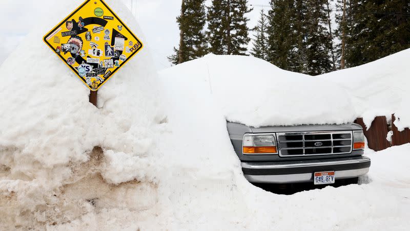 A truck is buried in snow in Brighton, on Monday, March 13, 2023.