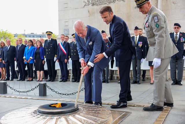 <p>Chris Jackson - WPA Pool/Getty Images</p> King Charles III performs the re-kindling of the eternal flame at the Arc de Triomphe in Paris, France on Sept. 20