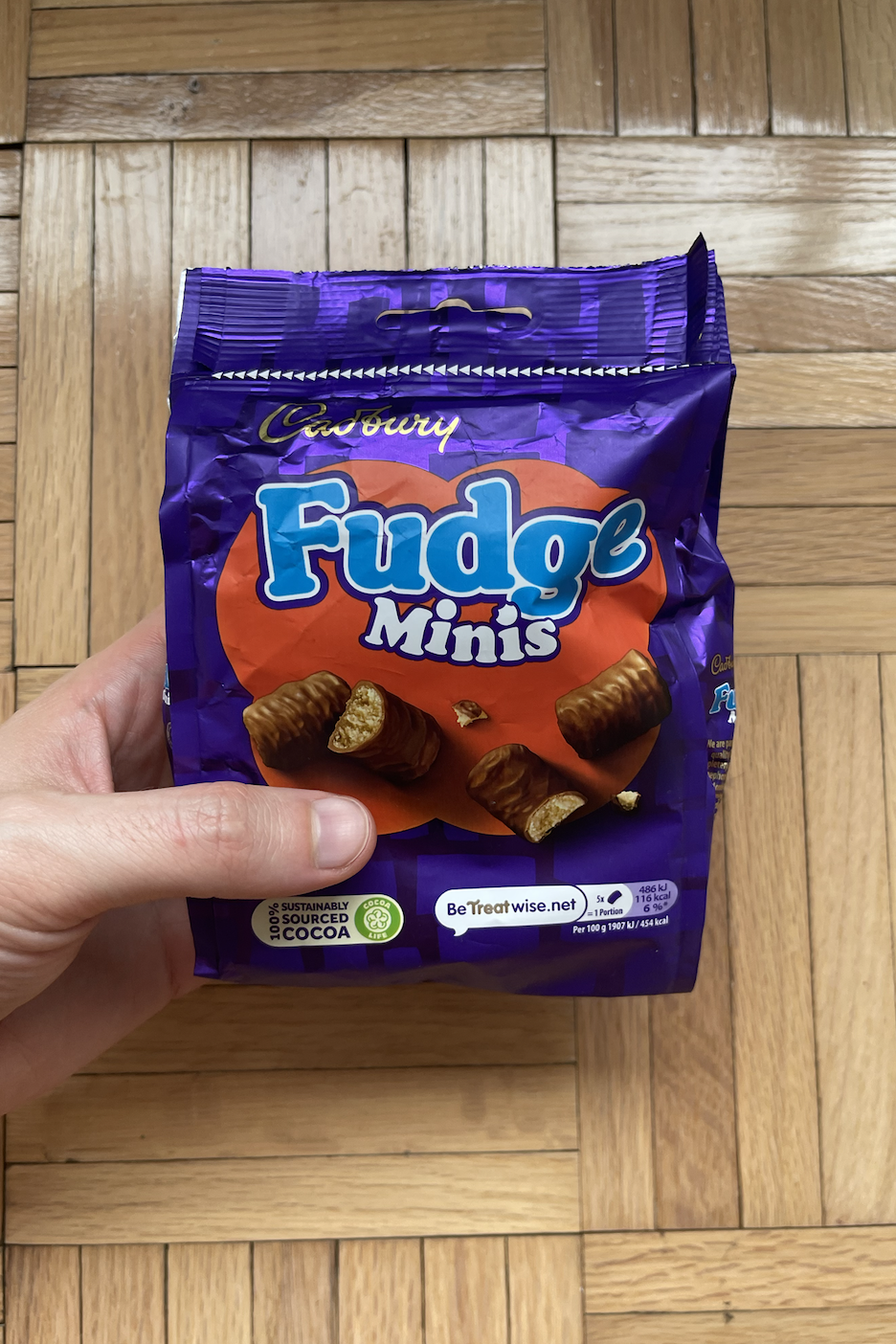 Hand holding a package of Fudge Minis