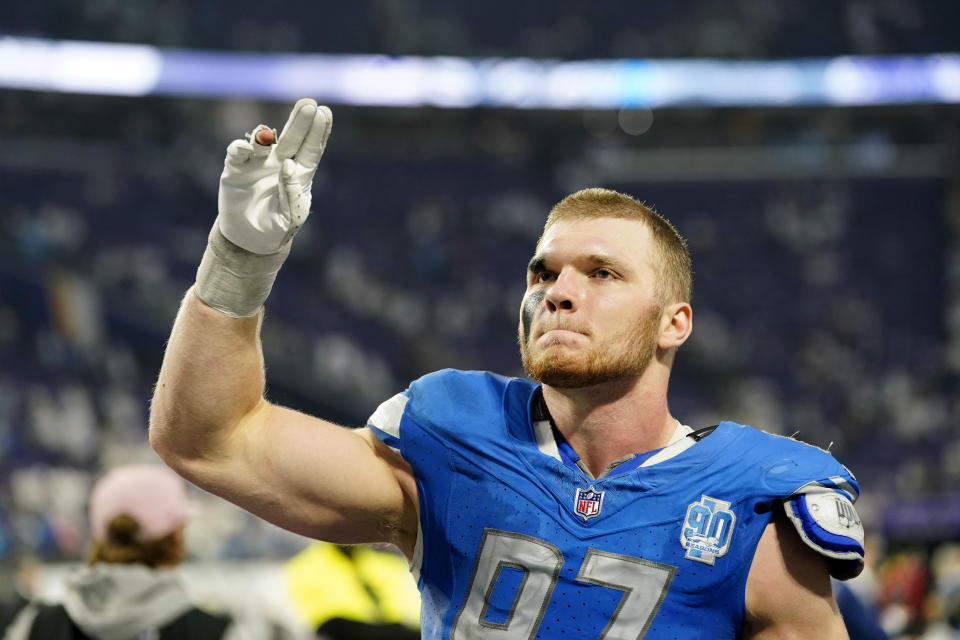 Detroit Lions defensive end Aidan Hutchinson (97) celebrates as he walks off the field after an NFL football game against the Minnesota Vikings, Sunday, Dec. 24, 2023, in Minneapolis. The Lions won 30-24. (AP Photo/Abbie Parr)
