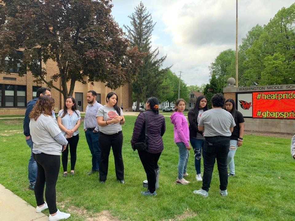 Members of the Northeast Wisconsin Latino Education Task Force gather outside Washington Middle School on May 19 in Green Bay. The group is calling for the Green Bay School Board to stop a plan to close 11 schools.