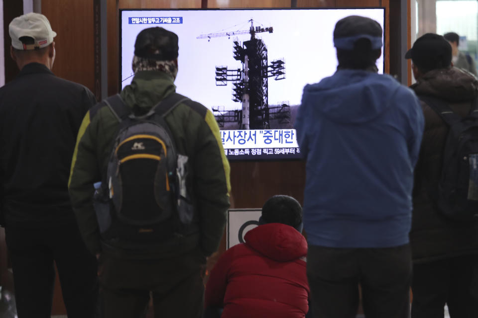 People watch a TV screen showing a file image of the North Korean long-range rocket at a launch pad during a news program at the Seoul Railway Station in Seoul, South Korea, Monday, Dec. 9, 2019. North Korea said Sunday it carried out a "very important test" at its long-range rocket launch site that it reportedly rebuilt after having partially dismantled it after entering denuclearization talks with the United States last year. (AP Photo/Ahn Young-joon)