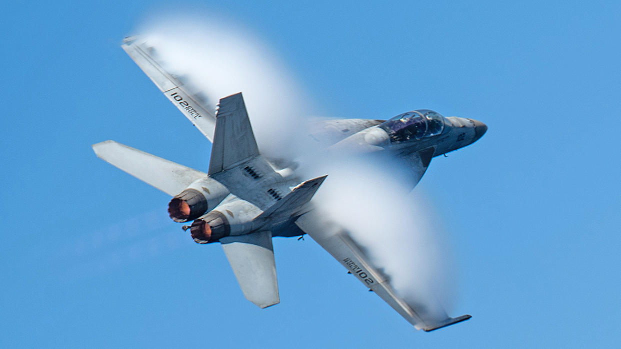 240416-N-HE057-1516 RED SEA (April 16, 2024) An F/A-18F Super Hornet, attached to the "Fighting Swordsmen" of Strike Fighter Squadron (VFA) 32, participates in an airborne change of command ceremony above the Nimitz-class aircraft carrier USS Dwight D. Eisenhower (CVN 69) in the Red Sea, April 16. The Dwight D. Eisenhower Carrier Strike Group is deployed to the U.S. 5th Fleet area of operations to support maritime security and stability in the Middle East region. (Official U.S. Navy photo)