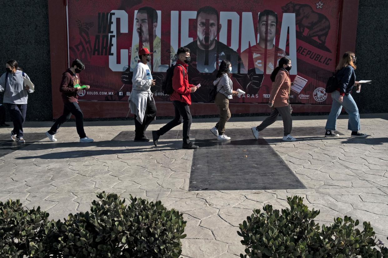 Youngsters queue to get vaccinated against COVID 19 during a vaccination journey for people between 15 and 17 years-old at the Caliente Stadium in Tijuana, Baja California state, Mexico, on November 24, 2021. (Photo by Guillermo Arias / AFP) (Photo by GUILLERMO ARIAS/AFP via Getty Images)