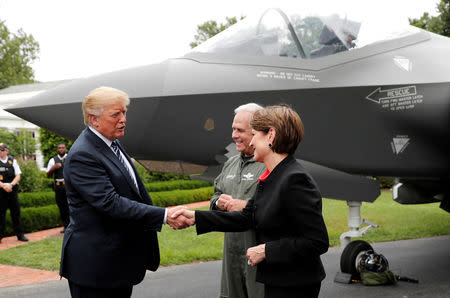 FILE PHOTO: U.S. President Donald Trump greets Lockheed Martin CEO Marillyn Hewson in front of a Lockheed Martin F-35 stealth fighter on the driveway abutting the South Lawn prior to delivering remarks at a showcase of American-made products event at the White House in Washington, U.S., July 23, 2018. REUTERS/Carlos Barria/File Photo