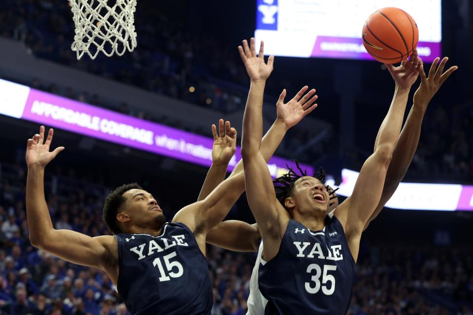 Yale's EJ Jarvis (15) and Isaiah Kelly (35) go for a rebound in front of Kentucky's Oscar Tshiebwe (34) during the first half of an NCAA college basketball game in Lexington, Ky., Saturday, Dec. 10, 2022. (AP Photo/James Crisp)