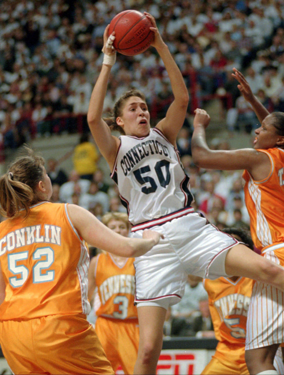 FILE - In this Jan. 16, 1995, file photo, Connecticut's Rebecca Lobo (50) pulls in a rebound as Tennessee's Abby Conklin (52) and Tiffani Johnson, right, defend during the first half of an NCAA college basketball game in Storrs, Conn. Lobo was elected to The Naismith Basketball Hall of Fame on Saturday, April 1, 2017. (AP Photo/Bob Child, File)