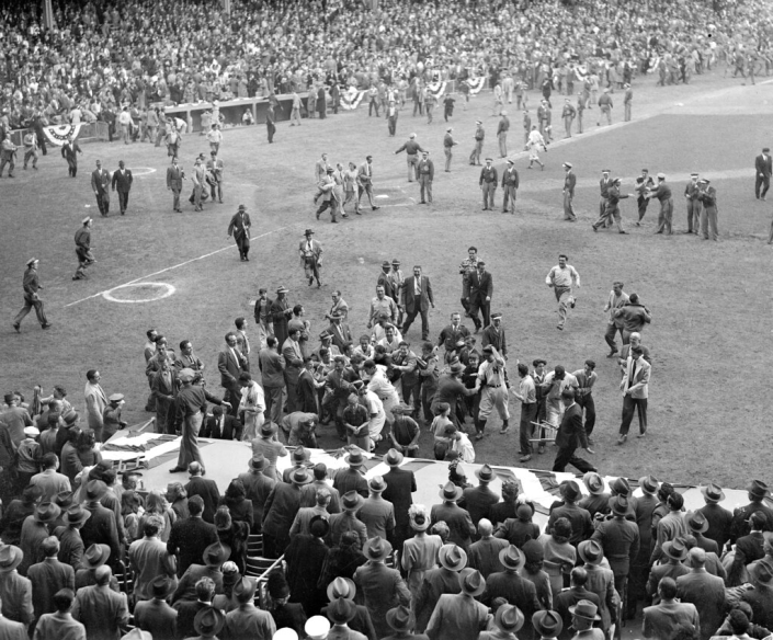 Fans swarm the Yankee Stadium field after the Yankees&#39; World Series title victory over the Brooklyn Dodgers.